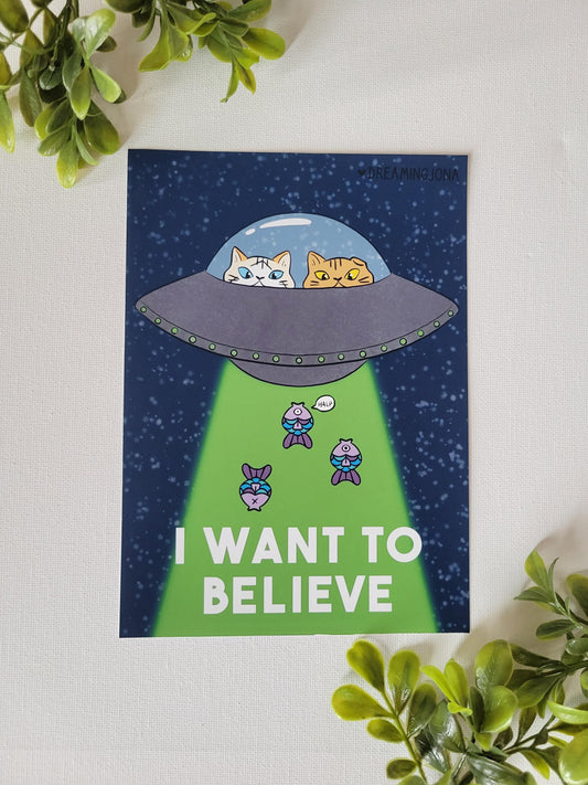 Cartoon poster of a UFO with cats and text 'I Want to Believe' on a white background.