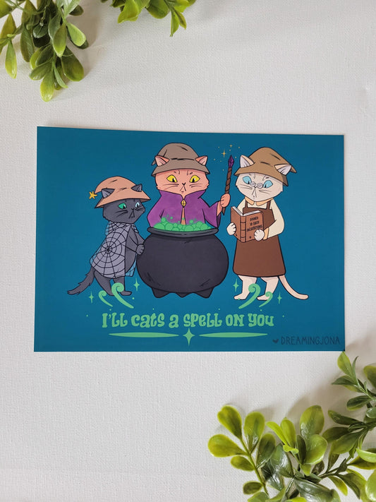 Cartoon cats in wizard costumes with a cauldron on a blue background
