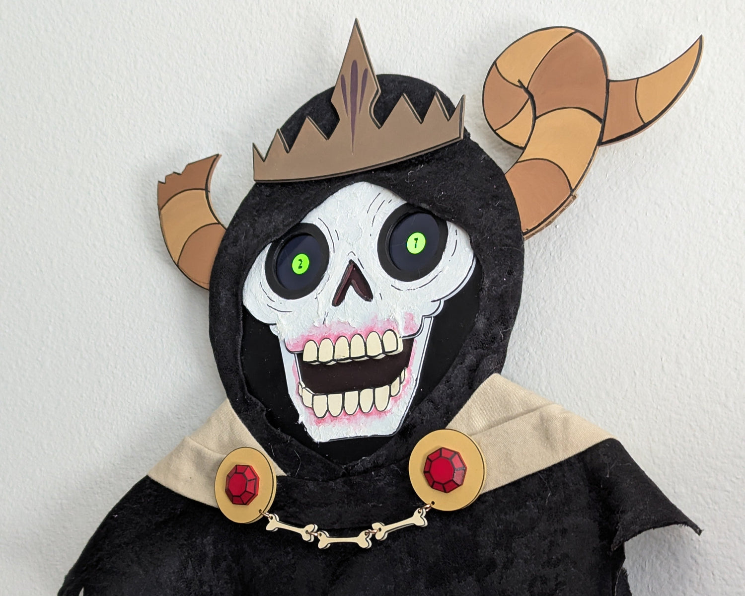 Adventure Time Lich Skull mask with black hood, crown, and red gemstones on a white background