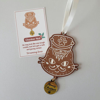 Cat-shaped ornament with a tag on a light gray background