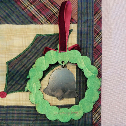 Decorative bell with green wreath and red ribbon