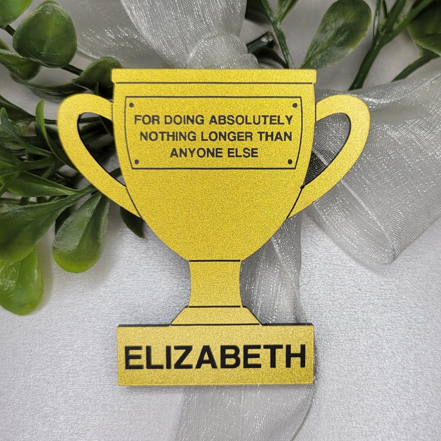 gold trophy-shaped name tag with customized name