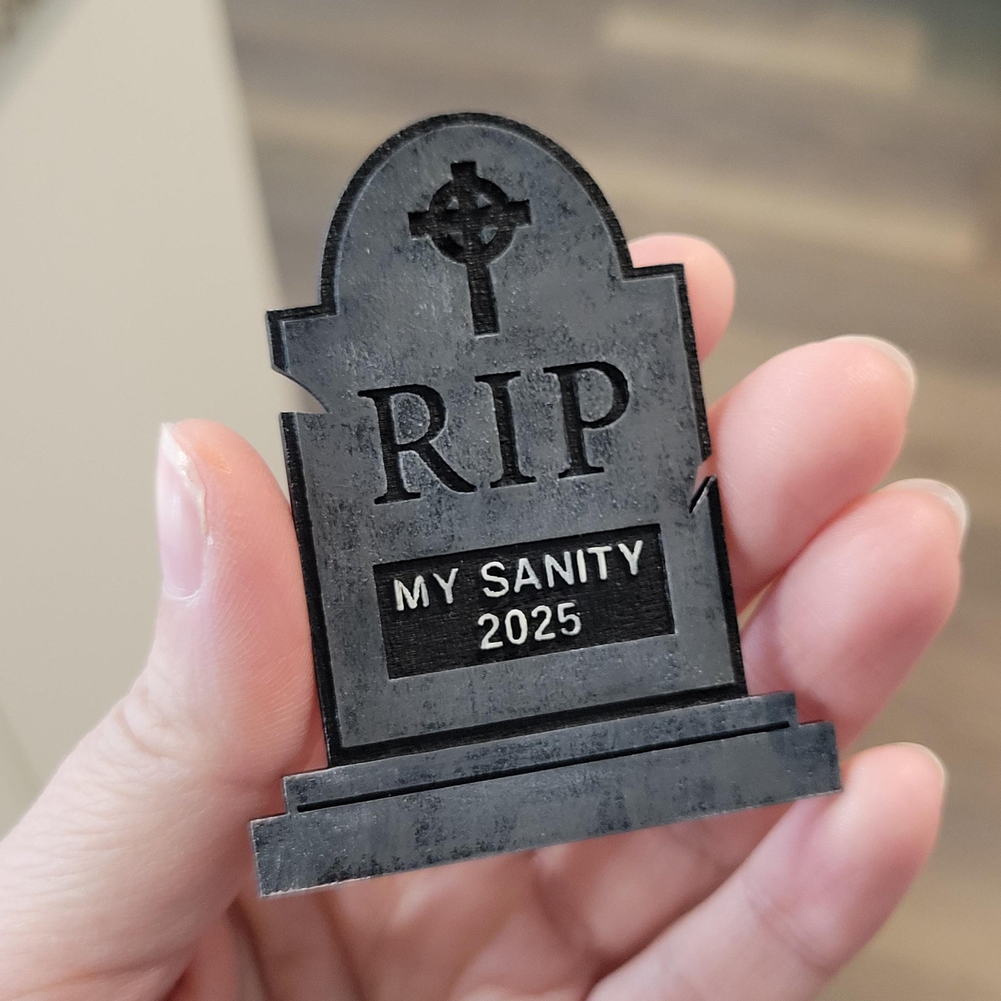 Small tombstone with 'RIP MY SANITY 2025