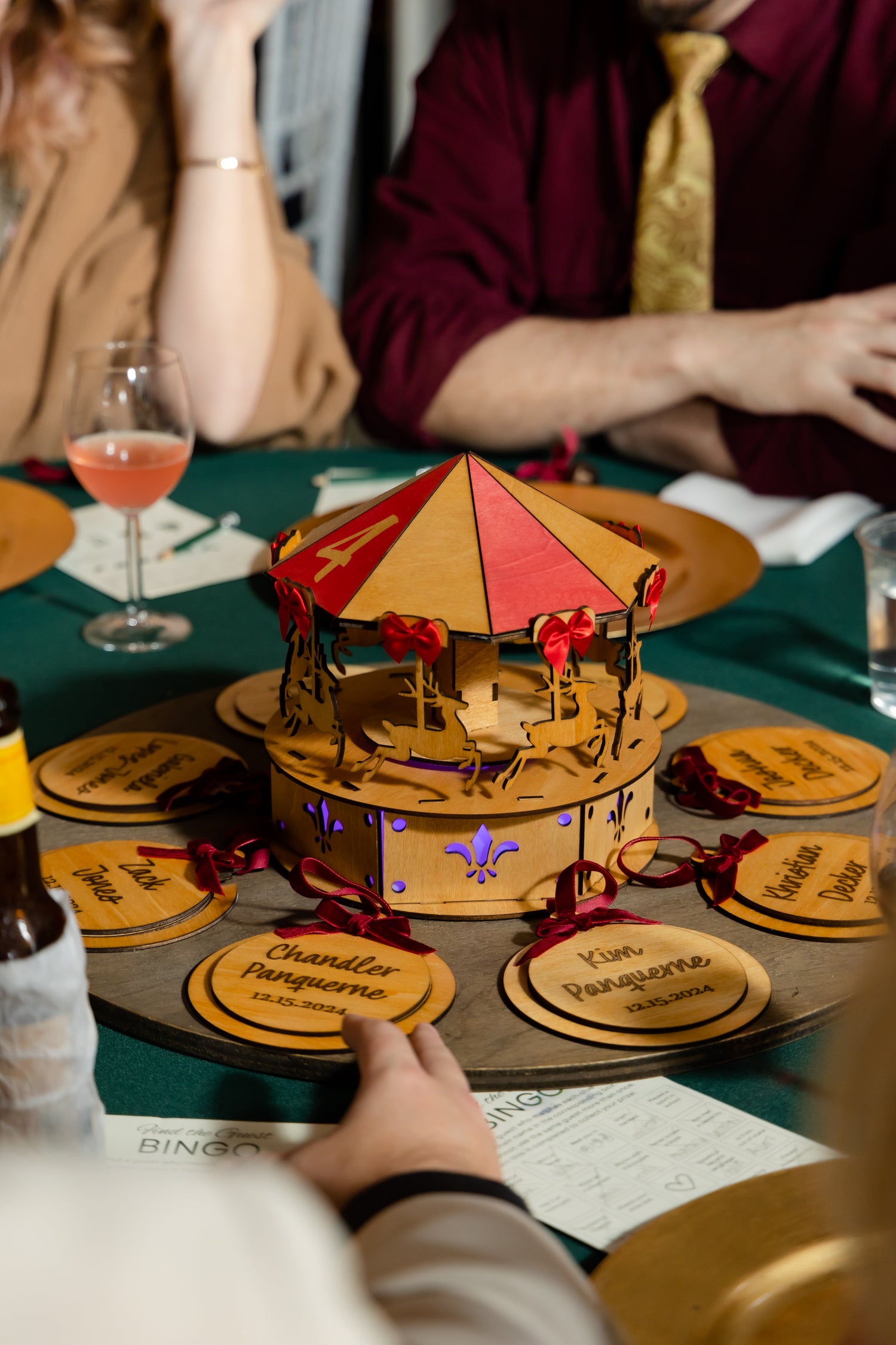 Wooden carousel on a table with people in the background