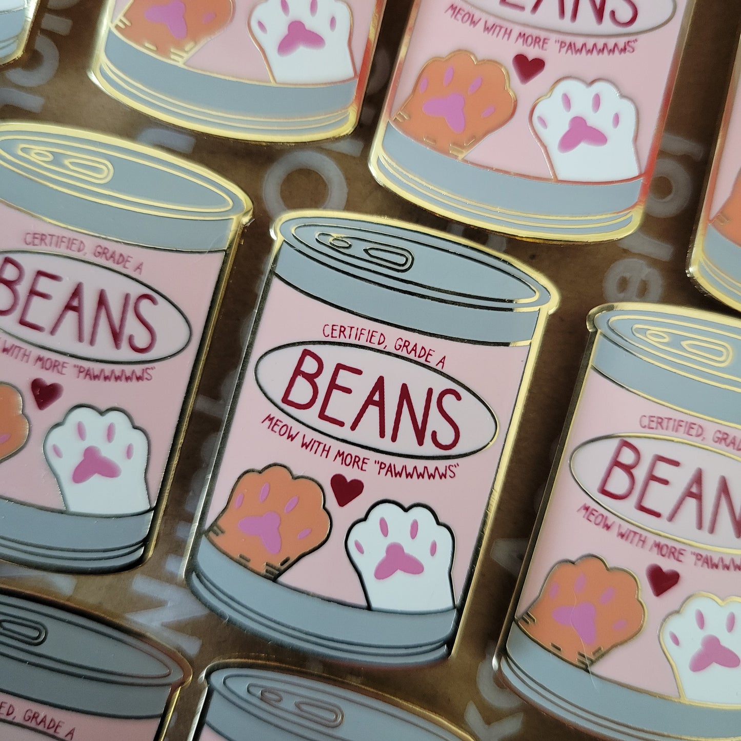 Collection of cat 'Beans' themed pins with a gold background