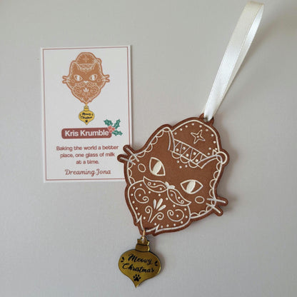 Decorative gingerbread santa cat ornament with a tag on a light gray background