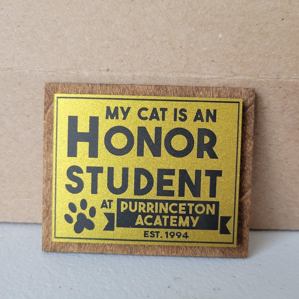 Gold sign with black text on a cardboard background