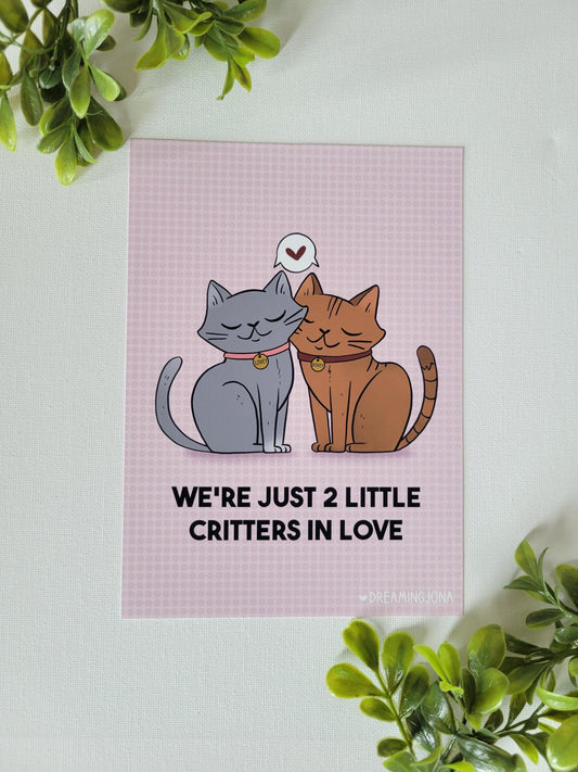 Cartoon of two cats with a heart above them on a pink grid background, surrounded by green plants.