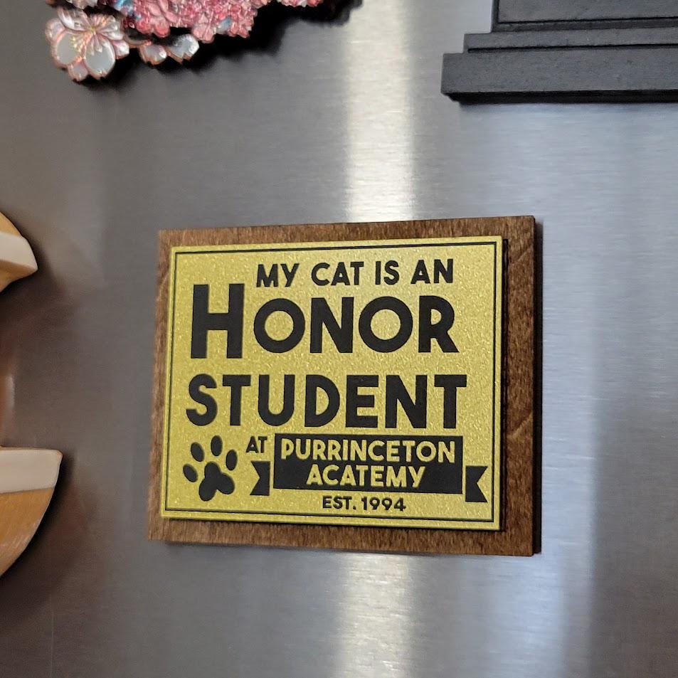 Fridge magnet with humorous text about a cat being an honor student at Purrinceton Acatemy