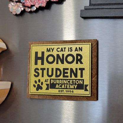 Fridge magnet with humorous text about a cat being an honor student at Purrinceton Acatemy