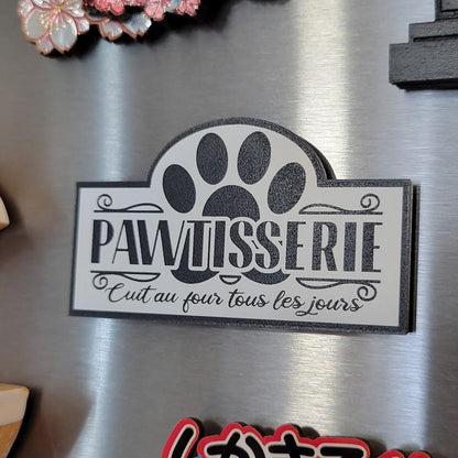 pawtisserie sign with paw print and text on a fridge