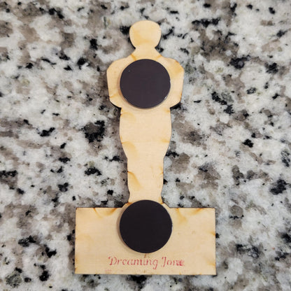 Wooden product with circular black magnets on a granite surface