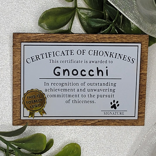 Certificate of Chonkiness with wooden frame on a light background with greenery