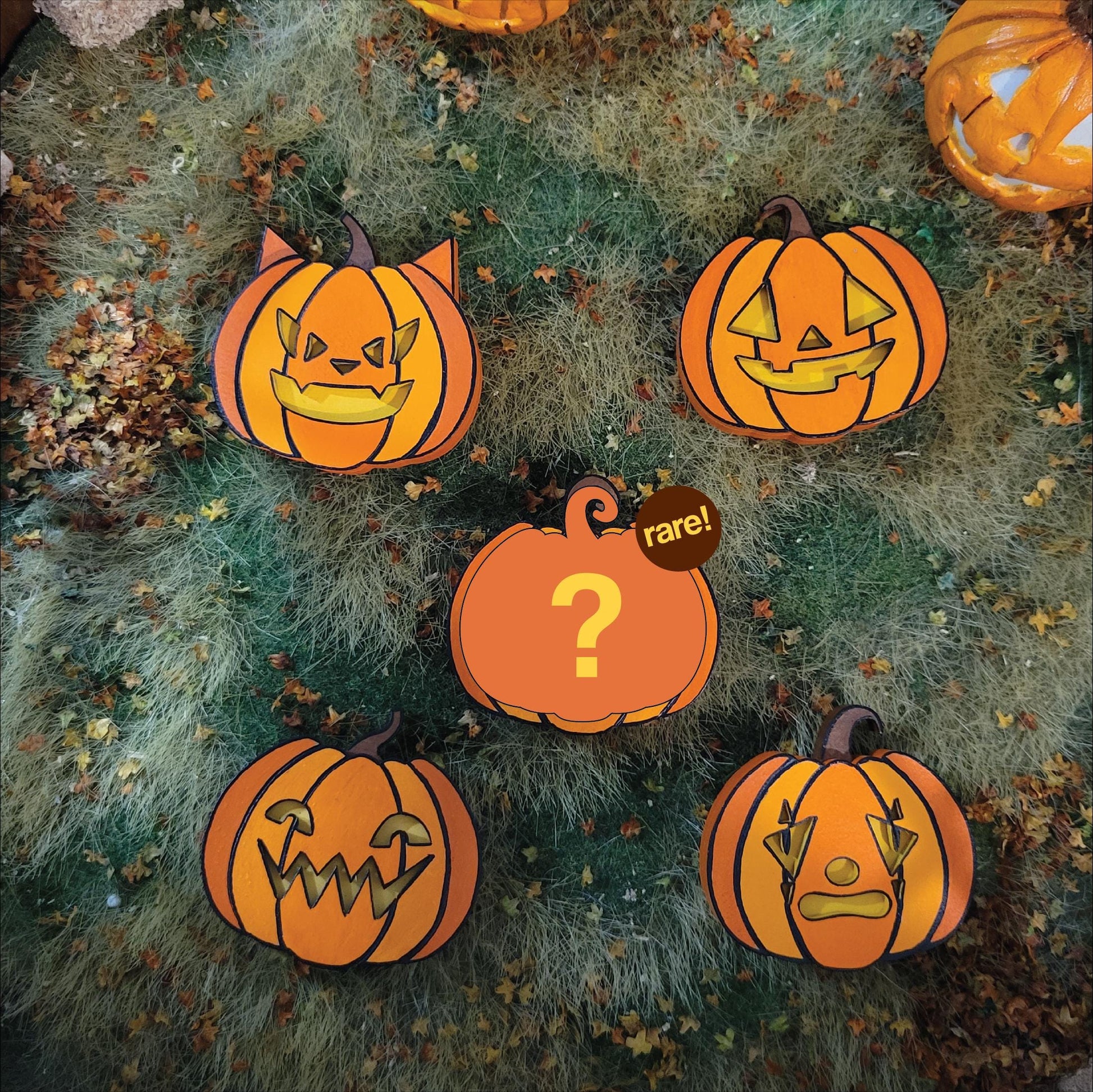 hand painted wooden pumpkins with various expressions on a textured background