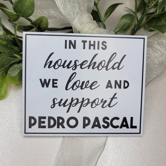 Decorative sign with black text and greenery on a white background